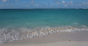 The Caribbean’s Flattest Island Has Miles of White Sand, Endless Lobster, and a Beach Called “Cow Wreck”