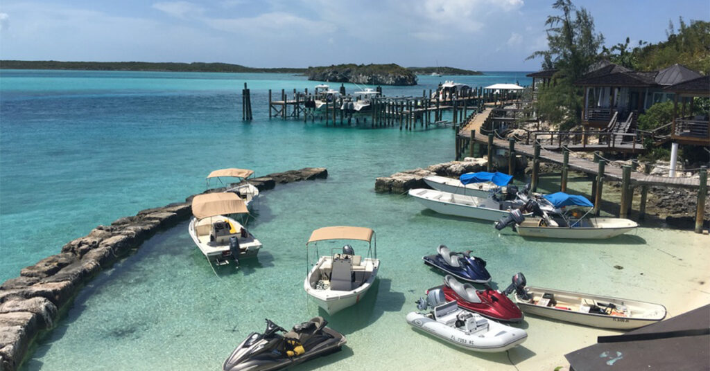 This Tiny Caribbean Island Has a Colorful Bungalow Hotel, Electric-Blue Water, and Swimming Pigs Nearby